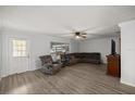 Spacious living room with modern flooring, ample seating, and a bright window at 4516 Ne 8Th St, Ocala, FL 34470