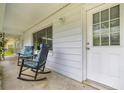 Inviting front porch with comfortable rocking chairs, perfect for relaxing outdoors at 4516 Ne 8Th St, Ocala, FL 34470