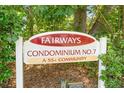 Fairways 7 Condominium No. 7 sign, noting it is a 55+ community, surrounded by lush greenery at 501 Fairways Ln # A, Ocala, FL 34472