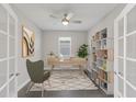 Bright home office with modern desk, ceiling fan, shelving unit, stylish decor, and neutral color palette at 5567 Nw 45Th Ln, Ocala, FL 34482