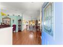 Inviting foyer showcasing hardwood floors and an open layout that flows into the dining and living areas at 5877 Sw 103Rd St, Ocala, FL 34476