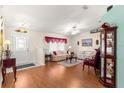 Bright living room featuring hardwood floors, cozy furniture, and a well-lit entryway for a welcoming ambiance at 5877 Sw 103Rd St, Ocala, FL 34476