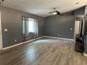 Spacious living room featuring gray walls, luxury vinyl flooring, and a modern ceiling fan at 6082 Sw 104Th St, Ocala, FL 34476