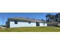 This home's backyard features a well-kept lawn perfect for outdoor enjoyment at 6134 Sw 155Th Street Road, Ocala, FL 34473