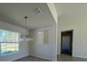 Bright dining room with modern chandelier and large window offering ample natural light at 6134 Sw 155Th Street Road, Ocala, FL 34473