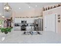 Well-appointed kitchen with stainless appliances, white cabinets, and a large sink at 6890 Sw 128Th Pl, Ocala, FL 34473