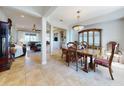 Spacious dining room with tile floors, traditional-style furniture and decor and direct access to the living room at 9172 Se 130Th Loop, Summerfield, FL 34491