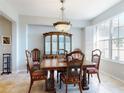 Bright dining room with tile floors, large window, and stylish furniture set at 9172 Se 130Th Loop, Summerfield, FL 34491