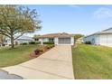 A well-kept, single-story home with nice landscaping and a long concrete driveway at 9741 Sw 97Th Ln, Ocala, FL 34481