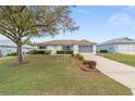 Single story home featuring a well manicured lawn and tidy landscaping at 9741 Sw 97Th Ln, Ocala, FL 34481