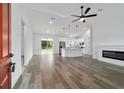 Bright open-concept living room with fireplace, and views into kitchen at 119 Water Trak, Ocala, FL 34472