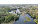 Stunning aerial view of a home nestled among trees and waterways at 12180 Maple St, Dunnellon, FL 34432