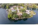 Overhead view of riverfront homes surrounded by lush trees and flowing waterway system at 12180 Maple St, Dunnellon, FL 34432