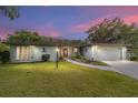 Charming single-story home featuring a manicured lawn and attached two-car garage, perfect for curb appeal at 12180 Maple St, Dunnellon, FL 34432