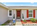 Close-up of the front entrance featuring a classic wood door and manicured landscaping at 15470 Sw 34Th Ave, Ocala, FL 34473