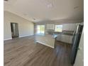 Bright, open-concept kitchen featuring a modern island, white cabinetry, and stainless steel appliances at 13269 Sw 112Th St, Dunnellon, FL 34432
