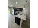 Well-equipped kitchen features stainless steel appliances, dark cabinets and sleek granite countertops at 15099 Sw 29Th Terrace Rd, Ocala, FL 34473