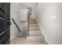 Bright entryway with hardwood stairs, modern railing and natural light streaming in at 341 Se 53Rd Ct, Ocala, FL 34480