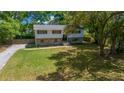 Charming two-story home with a well-manicured front yard, stone accents, and mature trees providing shade at 341 Se 53Rd Ct, Ocala, FL 34480