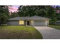 Charming single-story home features a well-manicured lawn and a spacious two-car garage at 5118 Sw 197Th Ter, Dunnellon, FL 34431