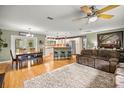 Open-concept living space with hardwood floors seamlessly connects the living room, dining area, and kitchen at 5118 Sw 197Th Ter, Dunnellon, FL 34431
