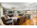 Inviting living room features hardwood floors, comfortable seating, and an open layout to the kitchen at 5118 Sw 197Th Ter, Dunnellon, FL 34431