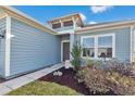 Inviting home entrance with manicured landscaping and a charming front door at 9312 Sw 58Th Cir, Ocala, FL 34476