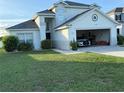 Charming home with a two-car garage, landscaping, and a green lawn at 4853 Sw 53Rd Rd, Ocala, FL 34474