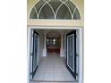 Grand front entrance showcasing decorative glass doors and tiled flooring at 5323 Sw 111Th Lane Rd, Ocala, FL 34476