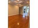Open-concept living room boasts hardwood floors, coffered ceilings, and natural light at 5323 Sw 111Th Lane Rd, Ocala, FL 34476