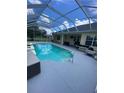 A screened pool with clear water and a hot tub, surrounded by a spacious deck at 5323 Sw 111Th Lane Rd, Ocala, FL 34476
