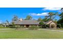 Expansive front yard showcases this home's architectural details and manicured landscaping, offering great curb appeal at 5950 Sw 21St Avenue Rd, Ocala, FL 34471