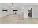 Open living area with tile floors, a ceiling fan, and access to the screened-in porch at 6701 Nw 6Th Ave, Ocala, FL 34475