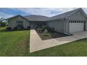 Charming single-story home with well-manicured lawn and decorative landscaping, including a two-car garage at 9188 Se 150Th St, Summerfield, FL 34491