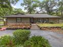 Charming single-story home with stone accents, landscaped garden beds, and a welcoming front porch at 4085 Se 23Rd Ter, Ocala, FL 34480