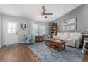 Comfortable living room features stylish furnishings, lots of light, hardwood floors, and an open layout at 1482 Abercrombie Way, The Villages, FL 32162