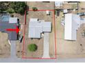 Aerial view of a property with a defined lot, including the house, driveway, and surrounding landscape at 3990 Se 20Th Ct, Ocala, FL 34480