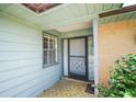 Inviting front porch featuring a decorative door, brick accents, and ample natural light at 3990 Se 20Th Ct, Ocala, FL 34480