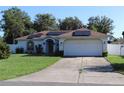 Charming single-story home with a well-manicured lawn and solar panels on the roof at 4413 Sw 145Th Place Rd, Ocala, FL 34473