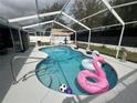 Inviting screened-in pool area featuring playful floaties and stylish tile accents at 4413 Sw 145Th Place Rd, Ocala, FL 34473