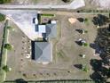 Aerial view of a landscaped home, including driveway, lawn, and the house's backyard at 11395 Se 108Th Terrace Rd, Belleview, FL 34420