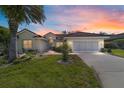 Charming single-story home with a well-manicured lawn at dusk at 11427 Sw 82Nd Ave, Ocala, FL 34481