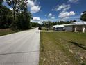 Street view of a single-story home in a quiet neighborhood, showing the house's setting at 15115 Se 94Th Ct, Summerfield, FL 34491