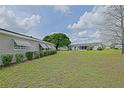The backyard with lush green grass and minimal foliage, a canvas for personalization at 17475 Se 107Th Ct, Summerfield, FL 34491