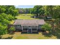 Attractive single-story home with a covered porch, situated on a large lot surrounded by mature trees at 2720 Se 145Th St, Summerfield, FL 34491