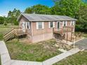 Charming two-story home featuring a wooden deck, walkway, and lovely landscaping against a blue sky at 2800 Sw 141St Ct, Ocala, FL 34481