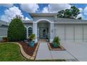 Inviting home entrance features a covered porch and landscaped yard with beautiful stone and mulch accents at 5195 Nw 21St Loop, Ocala, FL 34482