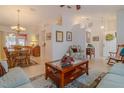 Open-concept living space with neutral decor, tile flooring, and an adjacent dining area at 5195 Nw 21St Loop, Ocala, FL 34482