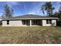 Expansive backyard with a covered patio, perfect for outdoor entertaining and relaxation at 6104 Sw 147Th Street Rd, Ocala, FL 34473