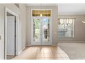 Bright foyer with tile flooring, French doors, and a view to the front yard at 802 Se 50Th Ter, Ocala, FL 34471
